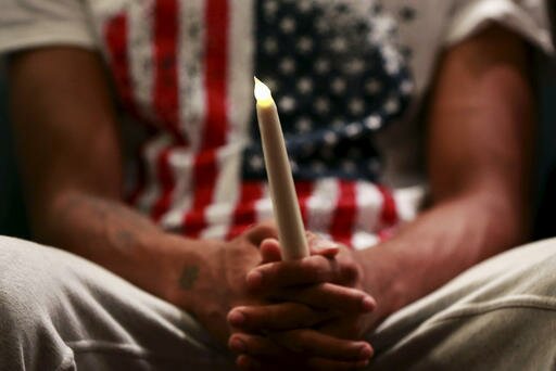 A family member of Eric Garner holds a candle during the Interfaith Prayer Service for Healing and Reconciliation at the Mount Sinai United Christian Church in the Staten Island borough of New York